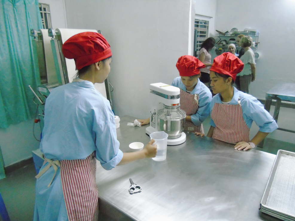 Girls preparing a mix for the cookies. Picture by Ian Russell (charityneeds.com).
