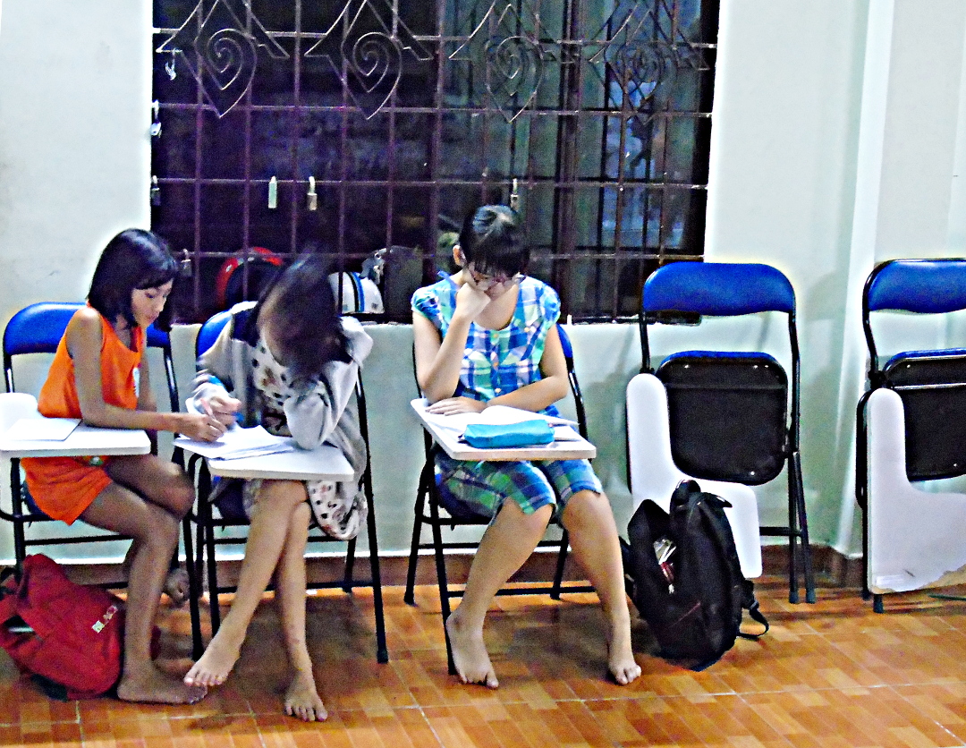 Girls catching up on homework.