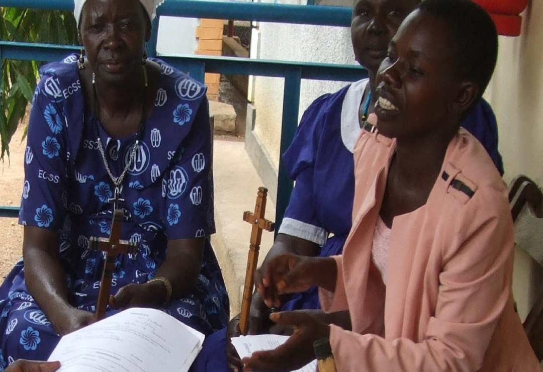 Manna Microfianance women holding prayers